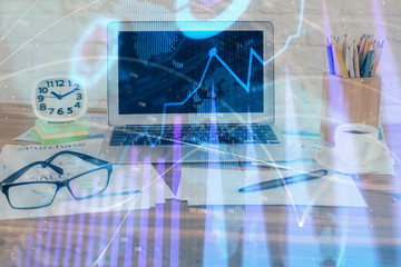 Financial chart drawing and table with computer on background. Double exposure. Concept of international markets.