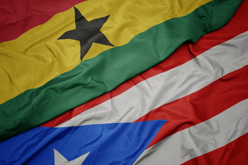 waving colorful flag of puerto rico and national flag of ghana.