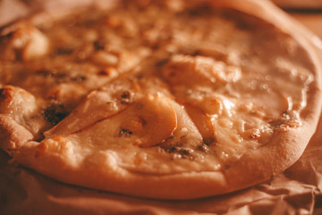 delicious fresh homemade pizza on the table. pizza with pear and green blue cheese