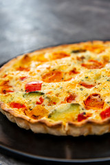 vegetable pie with cherry tomatoes, grilled peppers and courgettes with fresh eggs and fresh cream