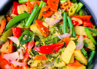 Asian cuisine, fresh green vegetables with meat, peas, peppers, zucchini, ingredients, for a hot menu