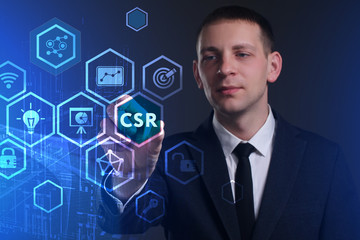 Business, Technology, Internet and network concept. Young businessman working on a virtual screen of the future and sees the inscription: CSR