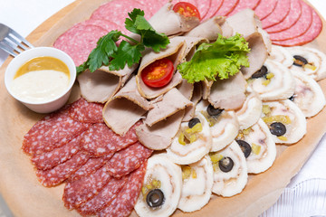 Fototapeta na wymiar sliced meat with sauce, sausage, bacon, salami, top view