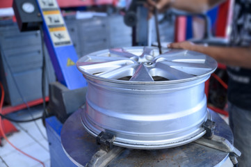 Mechanic remove used tire from rim for replace new tire on tire remove machine