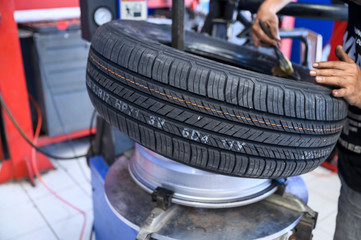 Mechanic replace new tire on rim by machine