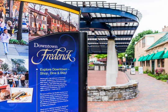 Frederick, USA - May 24, 2017: Carroll Creek in Maryland city park with sign and red brick area