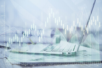 Financial graph colorful drawing and table with computer on background. Double exposure. Concept of international markets.