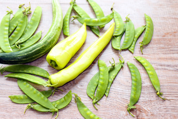 fresh green vegetables on a light background, peas, peppers, cabbage