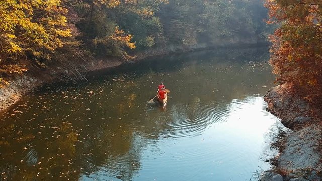 Two men canoeist paddling canoe, tracking shot
