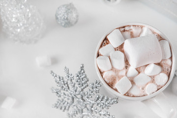 1 Cup hot chocolate with marshmallow, snowflake, silver balls, transparent herringbone, top view,