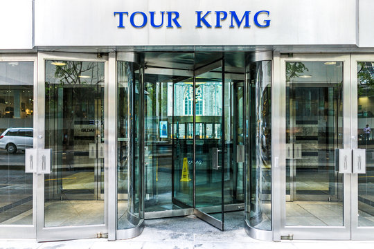 Montreal, Canada - May 26, 2017: Tour KPMG sign and entrance to building in downtown area of city in Quebec region with person at front desk