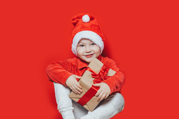 little boy holding christmas gift