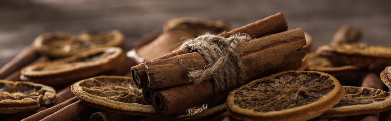 close up view of dried orange slices and cinnamon bunch, panoramic shot - Powered by Adobe