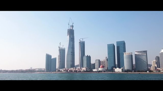 Skyline of Qingdao Bay and Buildings. New Property Development. Chinese Developers are Building New High Rises. Time-lapse and Hyperlapse.