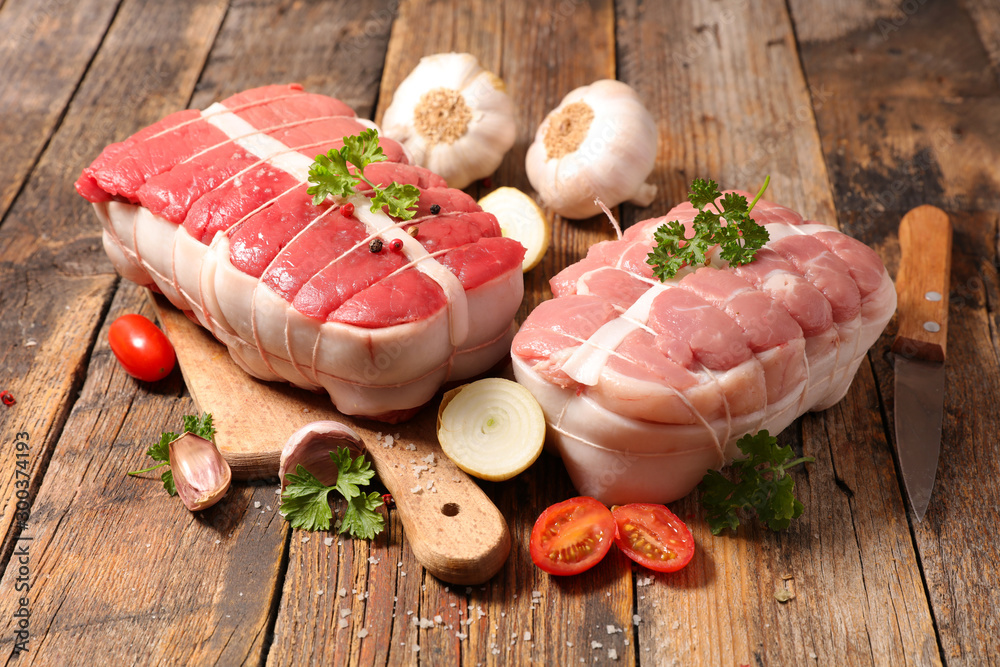 Wall mural raw meat, roast beef and veal on wooden board