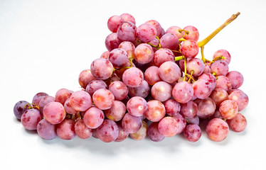 Ripe red grapes on a white background