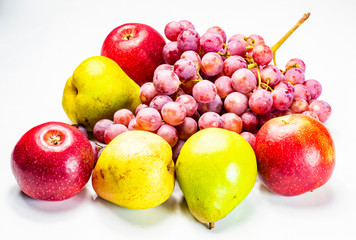 Ripe red grapes with pears and apples on a white background