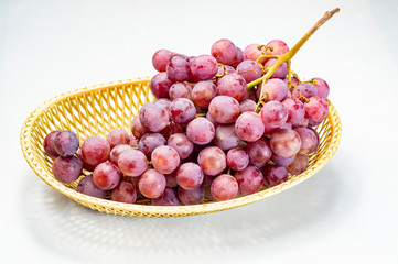 Ripe red grapes on a white background
