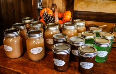 Variety of home canned goods on a wooden table