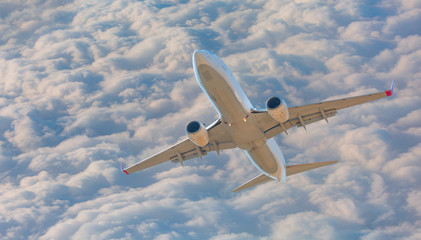 White passenger airplane in the clouds - Travel by air transport