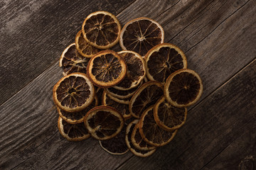 top view of dried citrus slices on wooden brown surface