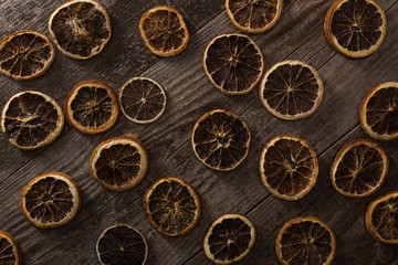 top view of dried citrus slices on wooden brown surface