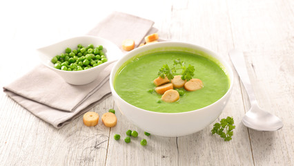 bowl of green vegetable soup and crouton