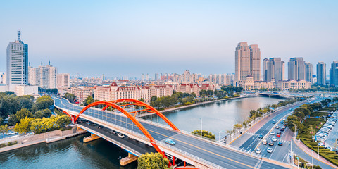 Fototapeta na wymiar Dusk scenery of Haihe River and Jingang Bridge in Tianjin, China