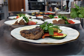 beef steak on a plate with herbs and vegetables