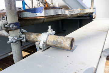 Scaffolding tube with clamp erected for structure installation on board a construction barge at oil field