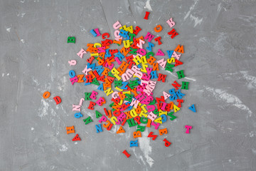 colored wooden English letters scattered
