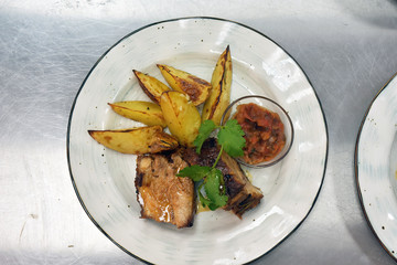 beef steak on a plate with herbs and vegetables