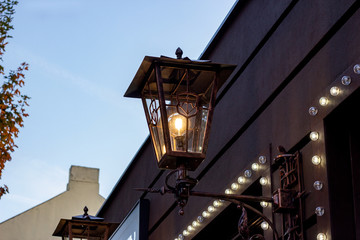Fototapeta na wymiar Old vintage city street lantern on blue cloudy sky background in the public place.