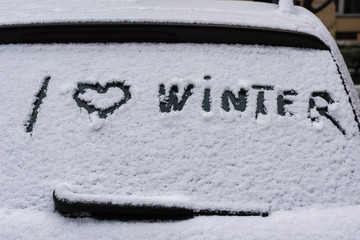 I love winter phrase on the car window. Winter concept