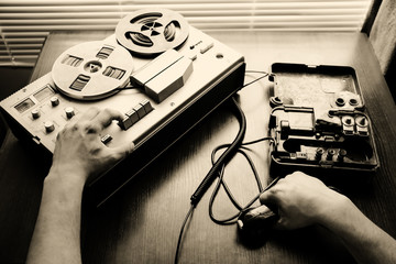 Special agent holds field telephone set USSR. Officer wiretapping   on the reel tape recorder. KGB...