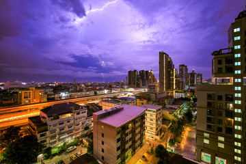 night.cityscape with lighting thunder on skyline