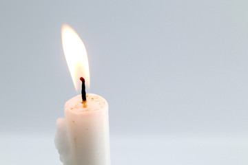 burning candle left side on white background