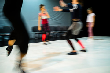 Motion blurred image of people rehearsing a contemporary dance show.