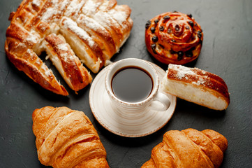 coffee and croissants on a stone background, morning breakfast