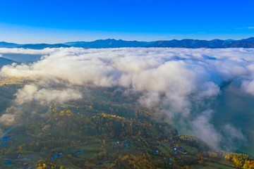 Fototapeta na wymiar Mist clouds over mountain valley