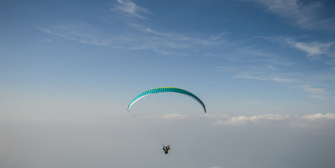 Paraglider flying over the Garda Lake,Panorama of the gorgeous Garda lake surrounded by mountains, Malcesine, Italy 