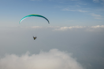 Paraglider flying over the Garda Lake,Panorama of the gorgeous Garda lake surrounded by mountains, Malcesine, Italy 