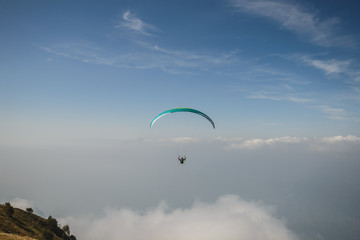 Paraglider flying over the Garda Lake,Panorama of the gorgeous Garda lake surrounded by mountains, Malcesine, Italy 