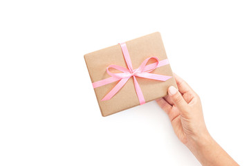 Female hands holding present box or gift box package in craft paper