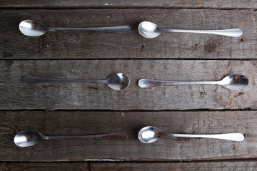 Vintage metal spoons on wooden table