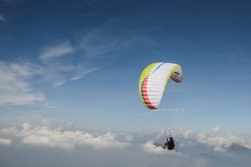 Paraglider flying over the Garda Lake,Panorama of the gorgeous Garda lake surrounded by mountains, Malcesine, Italy 