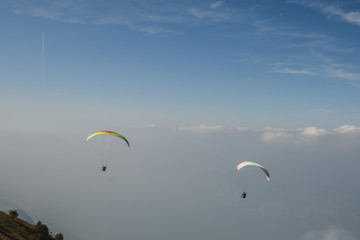 Paraglider flying over the Garda Lake,Panorama of the gorgeous Garda lake surrounded by mountains, Malcesine, Italy 