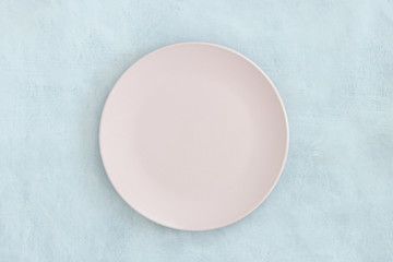 Empty black plate on dark stone background.