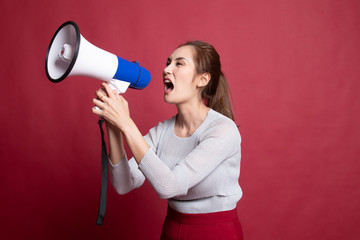 Beautiful young Asian woman announce with megaphone.