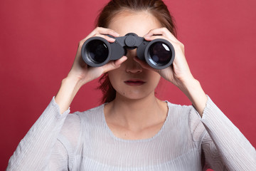 Young Asian woman with binoculars.